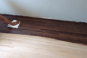 Hand sanding a wood floor